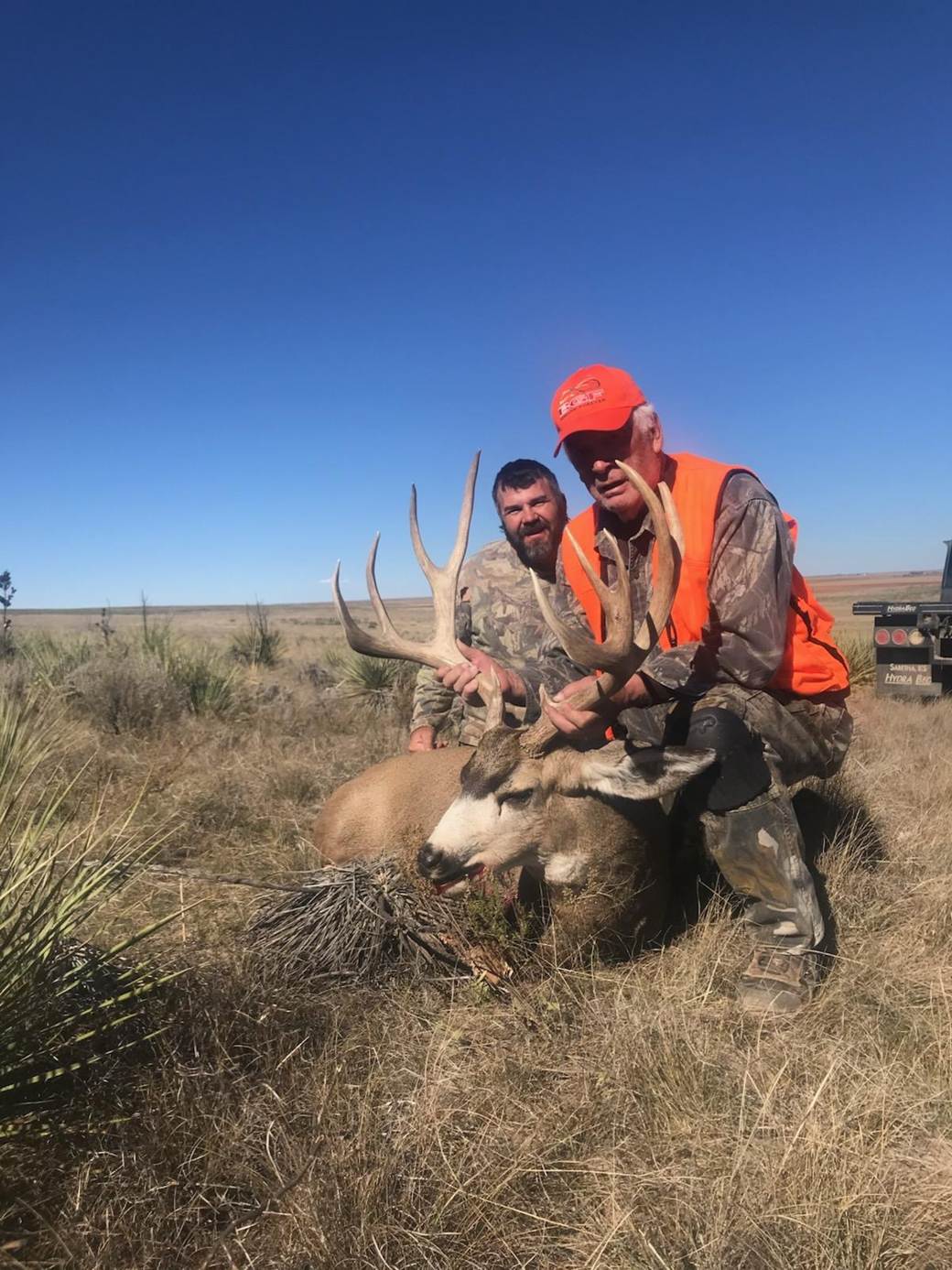 Guides and hunter with a heavy mule deer buck on Colorado's Eastern Plains